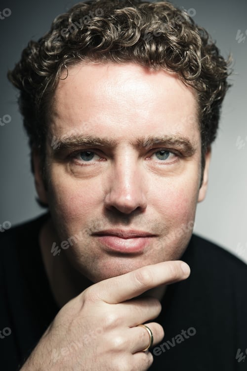 Preview: Studio Portrait Of Young Man Wearing Black Shirt Isolated On Grey Background