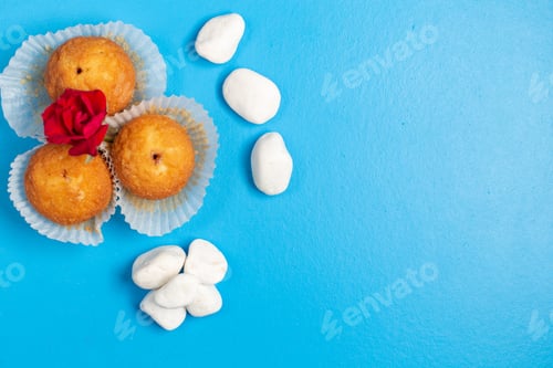Preview: top view little delicious cakes with white candies on the blue background color candy sweet sugar