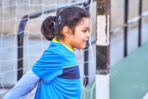 Preview: latin girl goalkeeper football player on a soccer goal