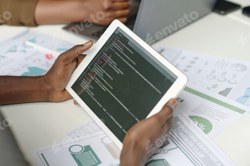 Preview: White Tablet with Codes in Male Hands