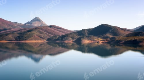 Preview: Beautiful shot of the river and mountain ranges on a blue sky background