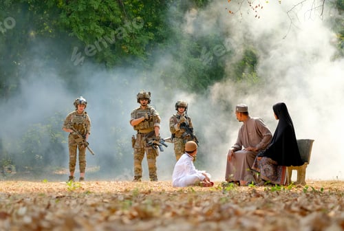 Preview: Muslim family sit near the jungle and look to soldier team with the concept of people during war