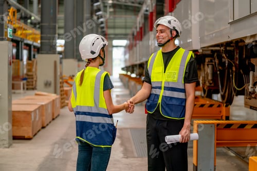 Preview: Engineer or factory technician worker man and woman shake hands for the success of joined project