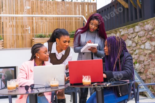 Preview: Young businesswomen of black ethnicity. In a business meeting in a cafeteria