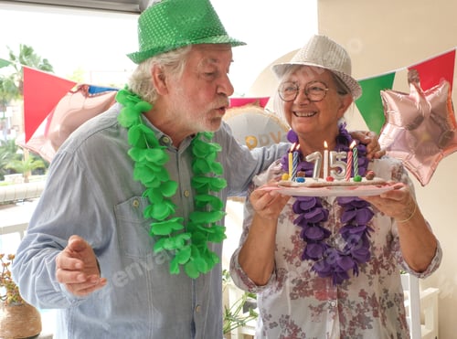 Preview: Joyful elderly couple celebrates a 75 birthday in a festive and colorful setting.