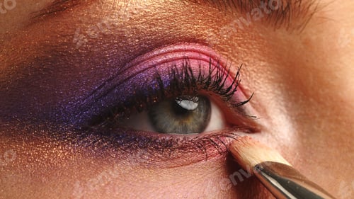 Preview: Make-up artist applies makeup to the upper eyelid, close-up. Makeup artist applies a bright shadow