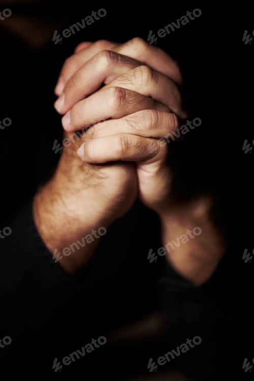 Preview: Praying hard for redemption. Hands clasped in prayer.