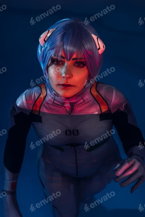 Preview: Vertical shot of a European female with blue hair in a swimming pool