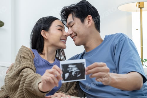 Preview: Couple Sharing Ultrasound Picture at Home
