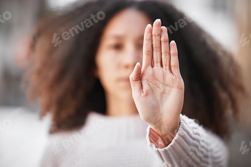 Preview: Shot of an unrecognizable woman making the stop sign with her hand outside