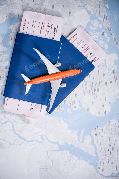Preview: composition of flight tickets with toy airplane laying on map