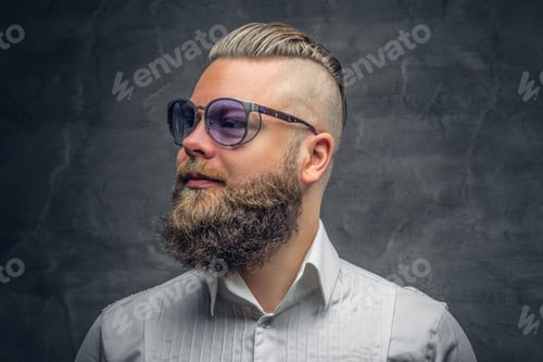 Preview: A bearded male in violet sunglasses, dressed in a white shirt.