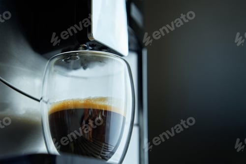 Preview: Coffee Machine Prepares Fresh Espresso in Clear Glass Against Dark Background