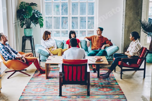 Preview: Pensive diverse friends sharing ideas while discussing general business project at home