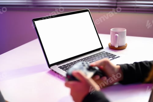 Preview: Hands holding game controller in front of a blank laptop screen with purple ambient light