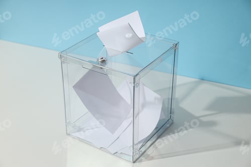 Preview: Voting box with papers on white table on blue background