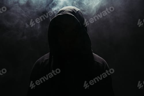 Preview: Silhouette of hooligan in hood on black background with smoke