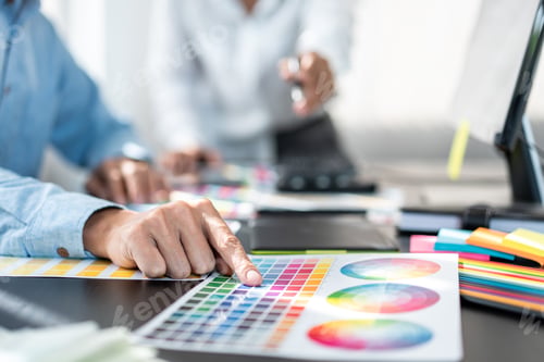 Preview: Two creative graphic designer team working on color selection and drawing on graphic tablet