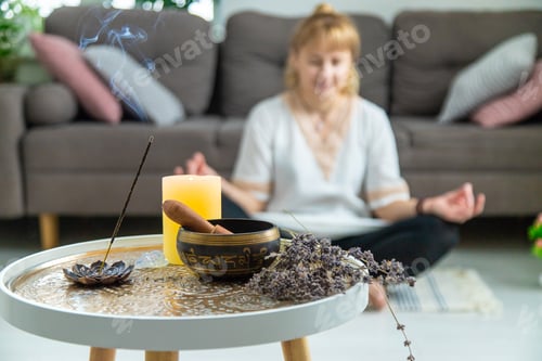 Preview: Woman doing yoga at home and aromatherapy. Selective focus.