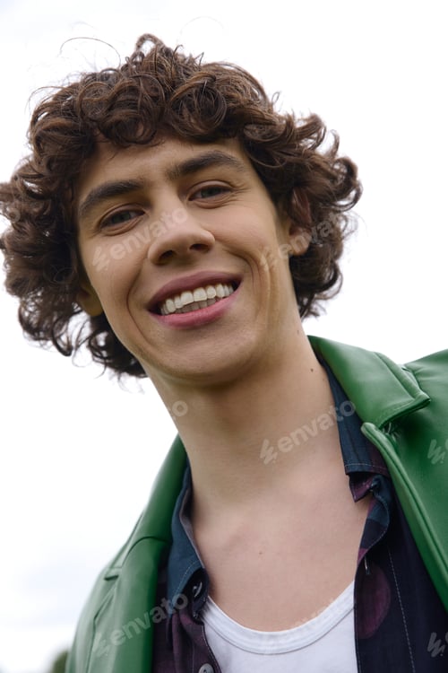 Preview: Young handsome student enjoys a refreshing outdoor walk surrounded by nature
