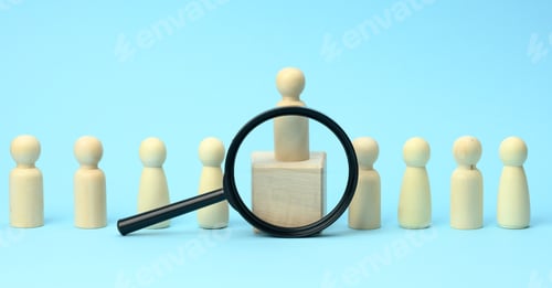 Preview: Wooden figures of men stand on a blue background and a black magnifying glass. Recruitment concept,