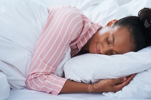 Preview: Sleeping just like a baby. Shot of an attractive young woman peacefully sleeping in bed at home.