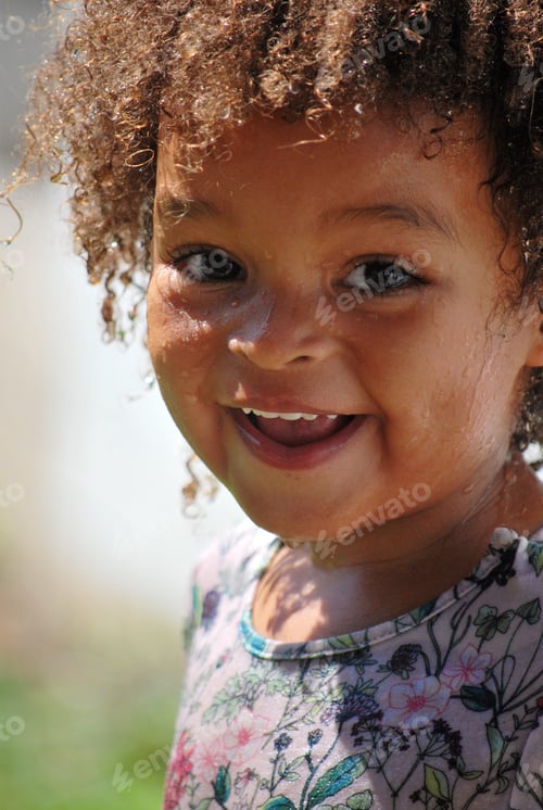 Preview: Summer fun - portrait of a little black girl / mixed girl having fun and playing water games