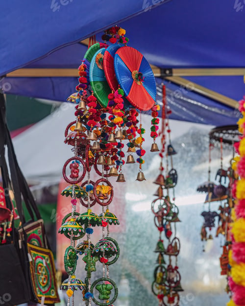 Preview: Indian handmade wind chimes with bells, decorated in colourful ornaments.