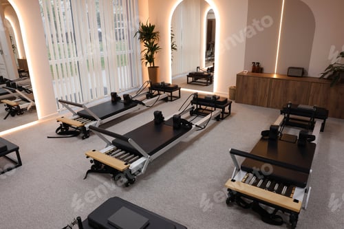 Preview: Reformer machines and mirrors in studio. Pilates equipment