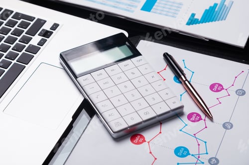 Preview: Modern calculator is on a laptop and on a sheet with a graph