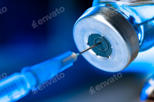 Preview: Vaccine bottle with a syringe taking the vaccine from it