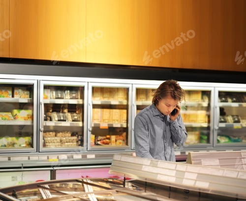 Preview: Man Choosing Frozen Food From A Supermarket Freezer