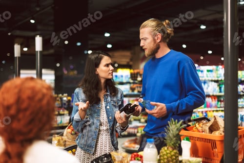 Preview: Young couple near cashier desk emotionally discussing something