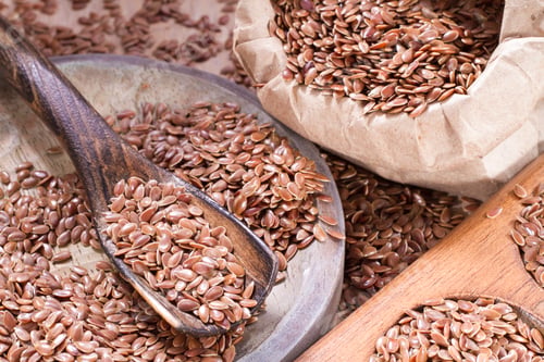 Preview: linseed seeds in container and spoon on the table