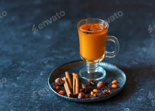 Preview: Sea buckthorn drink in a glass on a dark background.