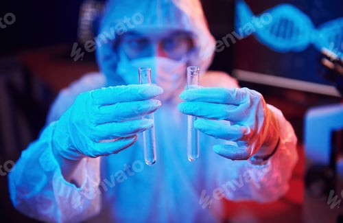 Preview: Nurse in mask and white uniform, holding tube with liquid and sitting in neon lighted laboratory