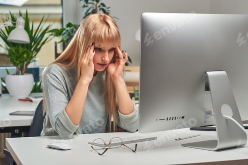 Preview: Woman feels tired while working in the office
