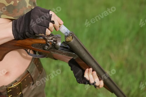 Preview: Process of loading shotshell into hunting double-barreled rifle