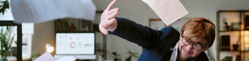 Preview: Header of Young Adult Man Throwing Documents in Air Expressing Frustration