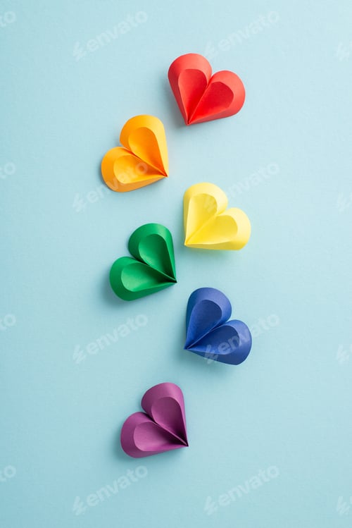 Preview: Vivid vertical multi-colored paper hearts arranged in a floating pattern on a gentle blue backdrop