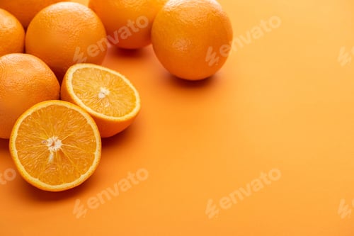 Preview: ripe delicious cut and whole oranges on colorful background