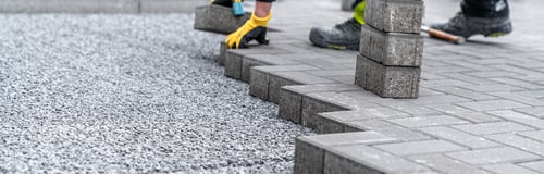 Preview: laying interlocking pavers during the construction of sidewalks and roads. banner with copy space