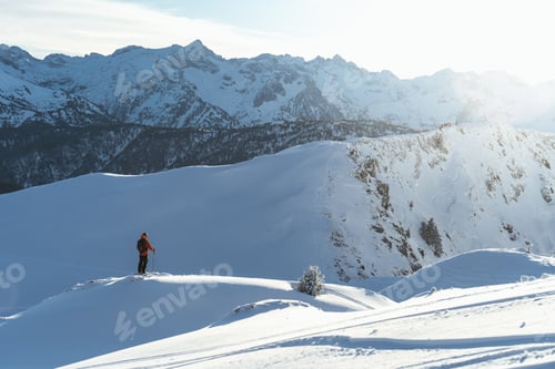 Preview: Skiers skiing and hiking in the snow-covered mountains