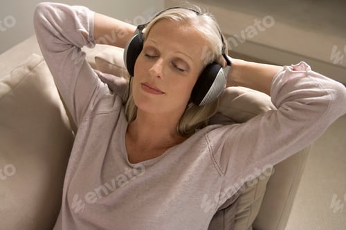 Preview: Mature woman wearing headphones