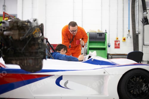 Preview: College mechanic students checking racing car in repair garage