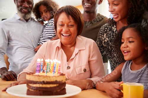 Preview: Multi-Generation Family Celebrating Grandmothers Birthday At Home With Cake And Candles
