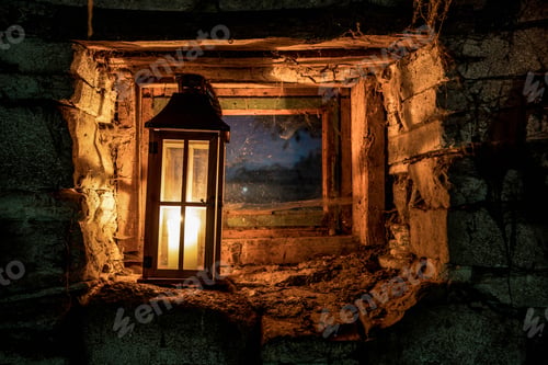 Glowing Lantern in Stone Wall at Night