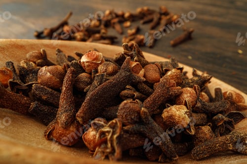 Preview: Heap of clove spice on wooden table