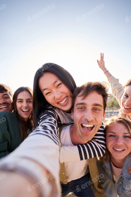 Preview: Group diverse happy young friend taking selfie together looking smiling at camera. Piggyback people.