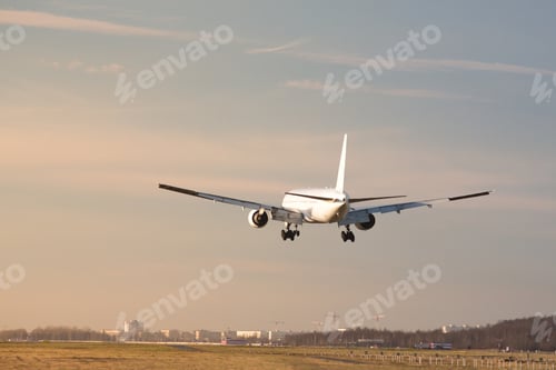 Preview: Airplane landing at airport in sunny day. Passenger aircraft almost landed at runway.